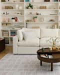White living room with Cozey Ciello sofa and built in bookshelves