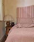 Red gingham Piglet in Bed bedding in rustic bedroom.