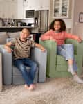 Children sitting on Nugget Smore's chair.