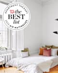 white stylish room with mattress with white linens and throw pillows on floor with seal in upper left that reads "Apartment Therapy the Best List 2023 Air Mattresses"