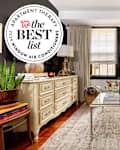 living room with window air conditioner unit. Seal in upper left reads "Apartment Therapy the Best List 2024 Window Air Conditioners"