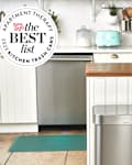 2023 Best Kitchen Trash Cans seal in front of photo of kitchen with a stainless steel trashcan