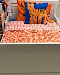 IKEA bed in store with personal shopper seal in upper right corner
