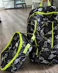 Backpack and lunch bag on kitchen floor.
