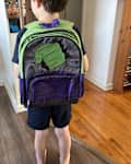 Child wearing Pottery Barn MacKenzie backpack.