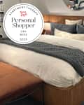 Bed at CB2 store with personal shopper seal in upper left