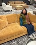 Cullen sitting on a sofa at Macy's store with a personal shopper seal in upper right