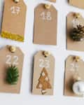 DIY advent calendar made of tags with small holiday decorations