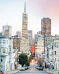 San Francisco cityscape with Transamerica Pyramid and surrounding buildings at sunset.
