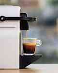 Making espresso. Espresso coffee maker on a wooden table. Blurred background, space for text, front view