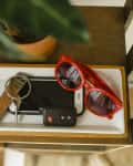 Catchall on entryway shelf with sunglasses, phone, keys, etc