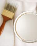 close up of paint can and paint brush