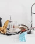 Pile of dirty dishes in kitchen sink