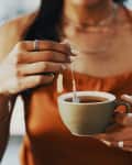 Cropped shot of a woman having a tea break at home.