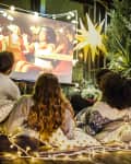 Friends making movie night at backyard
