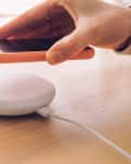 Wireless charging: a mobile phone being placed on a modern wireless power bank.
