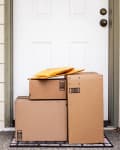 Front Door of House with Stack of Delivery Boxes from Online Ordering and E-commerce