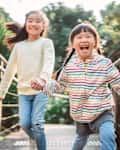 Little sibling playing joyfully in country side