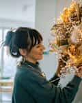 Young woman decorating her apartment for the upcoming holiday