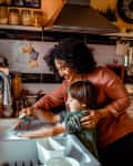 Mother and son washing dishes