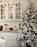 Interior white kitchen and light christmas decor. Preparing homemade cookies at kitchen. Festive kitchen in Christmas decorations. New Year and Christmas concept.