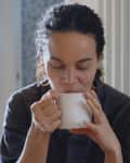 mixed race woman drinking tea in the morning