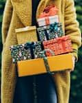 Woman holding Christmas gifts.