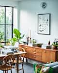 Modern lounge with dining table by large window set up as home office
