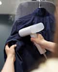 woman using garment steamer