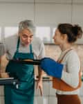 Teenage girl with her father cooking in kitchen together