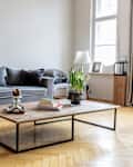 white sparse living room with gray sofa and no art