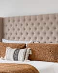 bedroom detail with a brown headboard and bedding