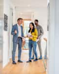 Male Real Estate Agent Selling And Showing The Modern Apartment To His Young Clients