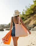 Young woman going to the beach alone