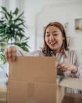 Young woman opening a package