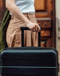 Young Asian woman with luggage finding direction while traveling. Travel and vacation. Lifestyle and technology.
