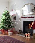 Living room with fireplace and Christmas tree surrounded with gifts