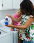 Young woman and little boy doing laundry