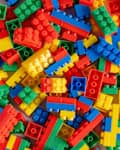 An overhead view of colorful building block scattered randomly.