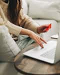 Woman hands using credit card and laptop for online shopping