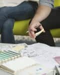 Two people reviewing architectural plans and color swatches on a table.