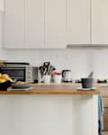 Home kitchen with white cabinets and an island