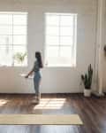 woman standing in a loft holding picture frame