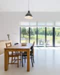 Spacious and bright open space with dining and relaxing areas and entrance to terrace