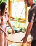 A woman and a man moving a table