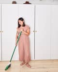 A woman sweeping the floor