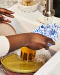 Person washing dishes at a kitchen sink
