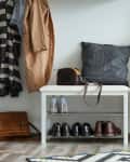 Stylish hallway interior with large mirror and shoe rack.