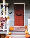 Halloween pumpkins and decorations outside a house