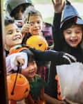 Little children trick or treating on Halloween